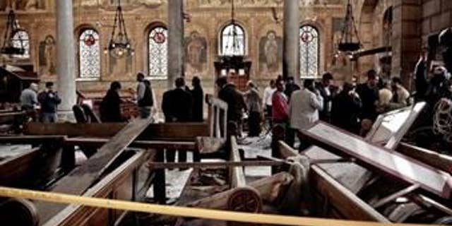 Security forces examine the scene inside the St. Mark Cathedral in central Cairo in December 2016, following a bombing that killed dozens of people.