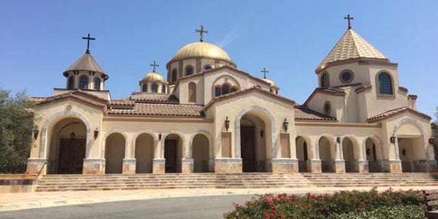 Members of the church were gathered under the main archway when the car passed slowly by, its occupant allegedly yelling "Allahu Akbar!" over a bullhorn.