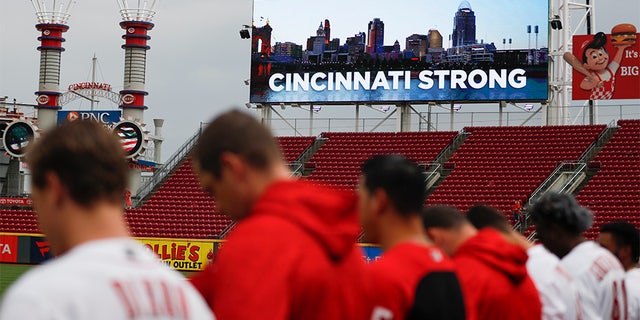 A moment of silence is observed in Cincinnati for the three dead and others wounded in a shooting downtown, at the Great American Ball Park before a baseball game between the Cincinnati Reds and the San Diego Padres.