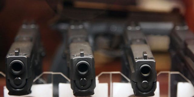 Jan. 4, 2013: Handguns are displayed in the sales area of Sandy Springs Gun Club and Range, in Sandy Springs, Ga.