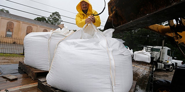 Volunteers put out sand bags due to the arrival of Tropical Storm Cindy in Lafitte, La., June 21.