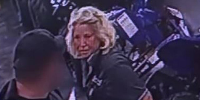 Image from surveillance video showing Jacksonville city worker confronting veteran as she served Jaguar Power Sports a citation for flying military flags.