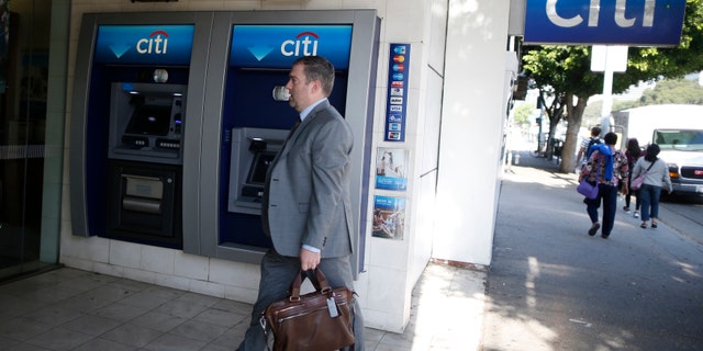 File photo - A man walks past a Citibank ATM in Los Angeles, California, March 10, 2015. (REUTERS/Lucy Nicholson)