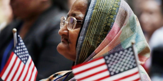 Hazera Khanom of Bangladesh listens during a naturalization ceremony, Tuesday, July 3, 2018, at the New York Public Library.