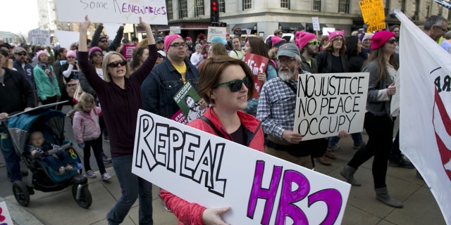 Protesters march up Fayetteville Street during the annual “Historic Thousands on Jones Street" (HKonJ) march in Raleigh, N.C., on Saturday, Feb. 11, 2017.