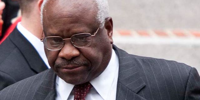FILE 2011: A standardized-test textbook publisher apologized Tuesday for a graphic in a European History booklet that lumped Supreme Court Justice Clarence Thomas with the KKK.