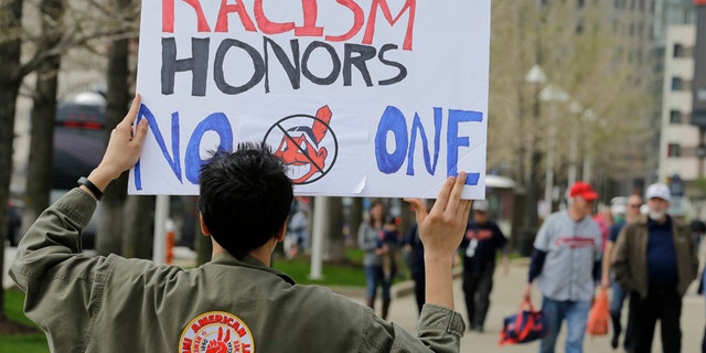 April 11, 2017: Josh Hunt protests as fans walk to the ballpark before a baseball game between the Chicago White Sox and the Cleveland Indians during opening day in Cleveland. Hunt is from the Cheyenne and Arapaho Tribe.
