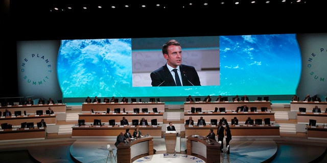 French President Emmanuel Macron delivers a speech at the One Planet Summit, in Boulogne-Billancourt near Paris, France, Tuesday, Dec. 12, 2017. More than 50 world leaders are gathering in Paris for a summit that President Emmanuel Macron hopes gives new momentum to the fight against global warming despite U.S. President Donald Trump's rejection of the Paris climate accord. (AP Photo/Christophe Ena)