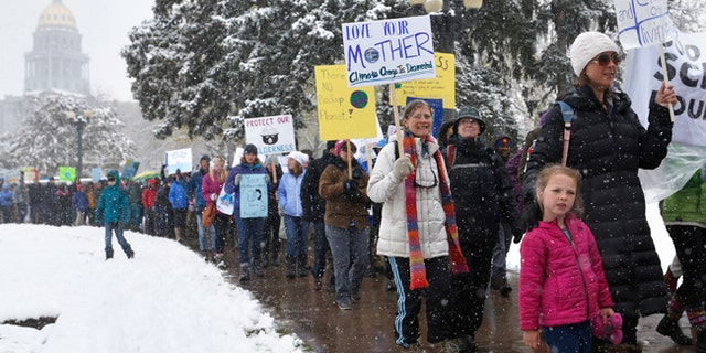 Marchers participate in a climate change awareness rally, in Denver, Saturday, April 29, 2017. The gathering was among many others of its kind held nationwide marking President Donald Trump's 100th day in office. (AP Photo/Brennan Linsley)