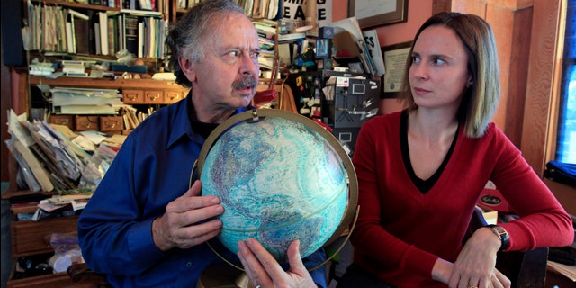 Richard Muller, left, and his daughter, Elizabeth Muller, hold a globe as they talk about their study on climate at their home in Berkeley, Calif.