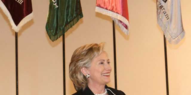 U.S. Secretary of State Hillary Clinton (R) sits onstage next to a teacher during her visit to Dar al-Hekma college for women in Jeddah February 16, 2010. REUTERS/Susan Baaghil (SAUDI ARABIA - Tags: POLITICS) - GM1E62H06YU01