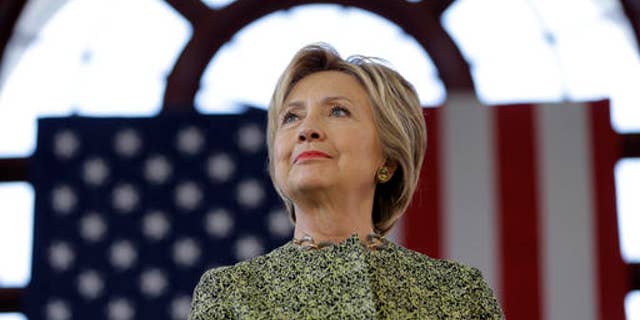 Democratic presidential candidate Hillary Clinton listens to a speaker at a rally in the Staten Island borough of New York, Sunday, April 17, 2016. (AP Photo/Seth Wenig)