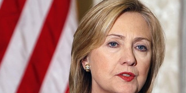 Secretary of State Hillary Clinton addresses reporters during a press conference at the U.S. embassy in Paris March 19.