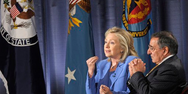 Secretary of State Hillary Clinton, accompanied by Defense Secretary Leon Panetta, speaks during an event at the National Defense University in Washington, D.C., Aug. 16.