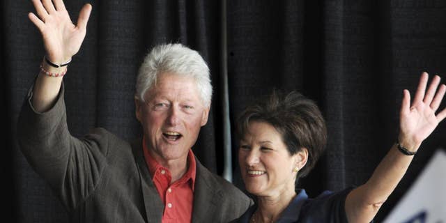 Former President Bill Clinton, left, joins Democratic gubernatorial candidate Alex Sink for an early vote rally in Miami at Miami Dade College North Campus, Thursday, Oct. 21, 2010. President Clinton addressed how critical voting for Sink is, especially during an election year that will so greatly impact the future of Florida. (AP Photo/The Miami Herald, Marice Cohn Band)