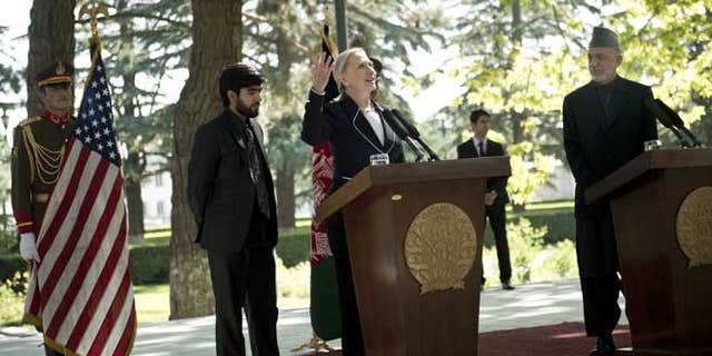 July 7, 2012: U.S. Secretary of State Hillary Rodham Clinton, second from right, speaks as Afghan President Hamid Karzai, right, listens during a press conference at the Presidential Palace in Kabul, Afghanistan.