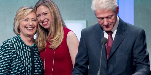 Former President Bill Clinton prepares to make remarks at the Clinton Global Initiative while his wife, Hillary Rodham Clinton, and daughter, Chelsea, take the stage with him, Tuesday, Sept. 24, 2013 in New York.