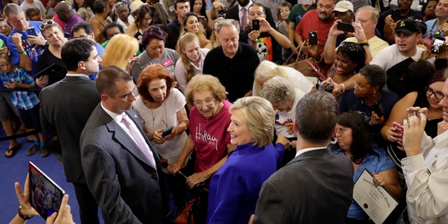 Democratic presidential candidate Hillary Clinton meets with attendees during a campaign stop at the Frontline Outreach Center in Orlando, Fla., Wednesday, Sept. 21, 2016.