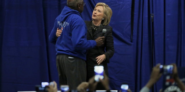 U.S. Democratic presidential candidate Hillary Clinton shares a hug with U.S. Representative Jim Clyburn on stage during Jim Clyburns Annual Fish Fry in Charleston, South Carolina January 16, 2016. REUTERS/Chris Keane - RTX22PQY