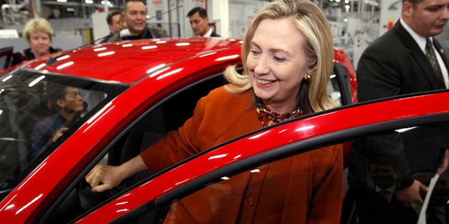 October 23, 2011: U.S. Secretary of State Hillary Clinton gets out of a GM "Spark" while touring the GM Powertrain plant in Tashkent, Uzbekistan.