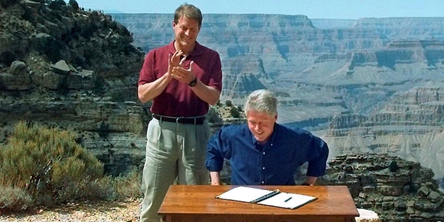 Vice President Al Gore applauds after President Bill Clinton signs a bill designating about 1.7 million acres of land in southern Utah's red-rock cliff as the Grand Staircase-Escalante National Monument, at the Grand Canyon National Park, in Arizona In this Sept. 18, 1996.