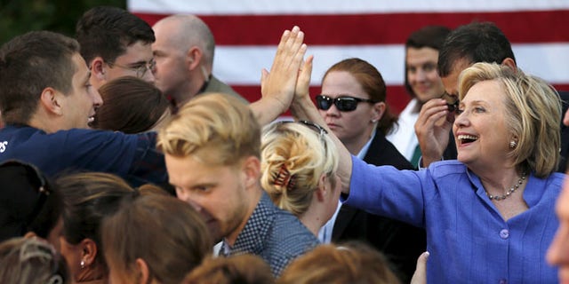 Aug 10, 2015: U.S. Democratic presidential candidate Hillary Clinton high-fives a supporter at a campaign stop in Manchester, New Hampshire. (Reuters)