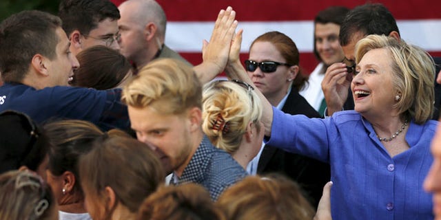 Aug 10, 2015: U.S. Democratic presidential candidate Hillary Clinton high-fives a supporter at a campaign stop in Manchester, New Hampshire. (Reuters)