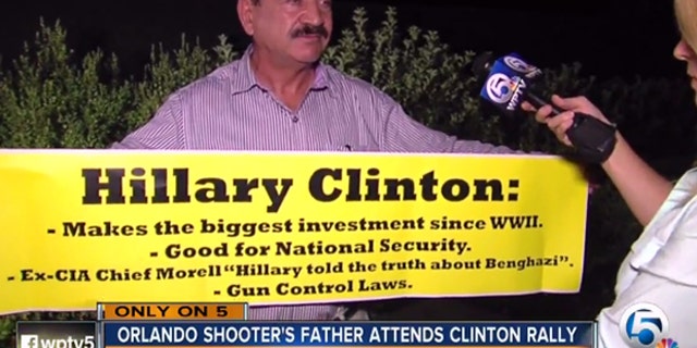 Seddique Mateen holds up a pro-Clinton sign, during an interview Aug. 8 with WPTV.