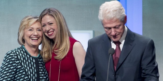 The Clintons don't draw salaries from their family foundation, but critics say they benefit in other ways. (AP)