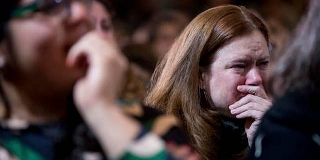 FILE - Staff and supporters listen as Democratic presidential candidate Hillary Clinton speaks at the New Yorker Hotel in New York, Wednesday, Nov. 9, 2016, where she conceded her defeat to Republican Donald Trump after the hard-fought presidential election.