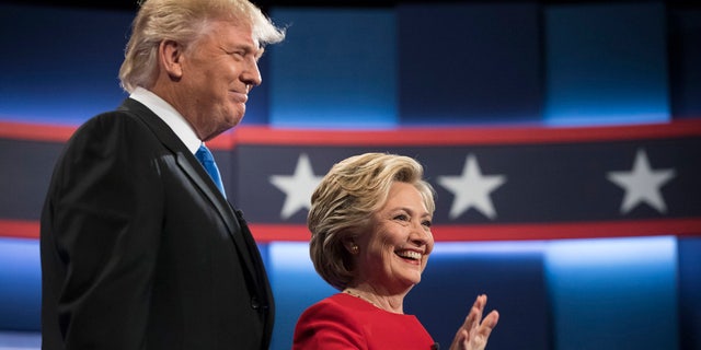 Democratic presidential nominee Hillary Clinton, right, stands with Republican presidential nominee Donald Trump at the start of the presidential debate at Hofstra University in Hempstead, N.Y., (AP Photo/Matt Rourke)