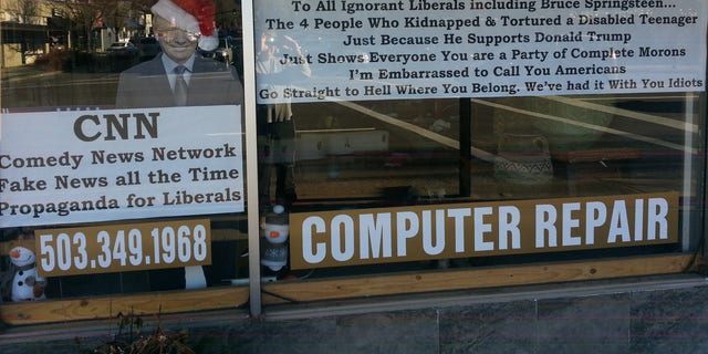 He put this giant sign in the window of his store in Lake Oswego, Oregon.
