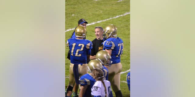 Former Bremerton High School assistant football coach Joe Kennedy stands at the center of the field on the 50 yard line at Bremerton Memorial Stadium. 