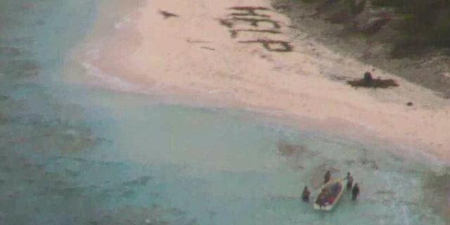 A small boat from Pulap recovers three men from the uninhabited island of Fanadik after they were discovered by a U.S. Navy P-8A. (U.S. Navy photo)