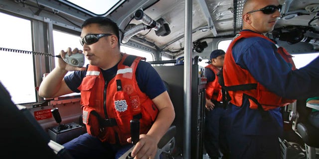 Jan. 28, 2014: Coast Guard officer William Pless communicates on the radio  during a patrol off the San Diego coast. With the drug war targeting land routes across Latin America and the U.S. border, smugglers have been increasingly using large vessels to carry multi-ton loads of cocaine and marijuana hundreds of miles offshore.