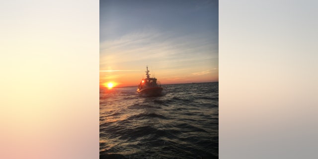 A 45-foot Response Boat-Medium crew from Coast Guard Station Wrightsville Beach approaches a capsized vessel near Masonboro Inlet, North Carolina, June 28, 2017.