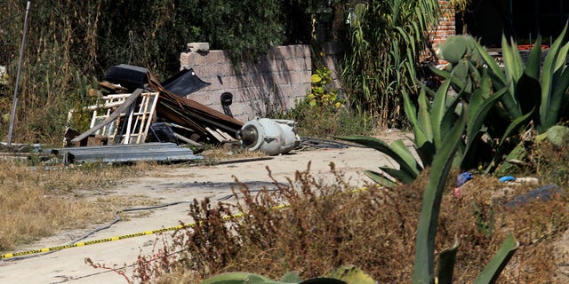 A container reportedly used to transport cobalt-60 (C) is seen at a home near where the dangerous radioactive medical material was found in a truck in the town of Hueypoxtla, near Mexico City December 5, 2013. (REUTERS/Henry Romero)