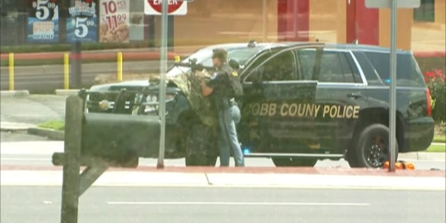 A man who claimed that he had a bomb inside a Georgia bank has died, police said.