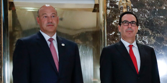 President Donald Trump speaks to the media in the lobby of Trump Tower, Tuesday, Aug. 15, 2017 in New York. With Trump are from l-r., National Economic Council Director Gary Cohn, Treasury Secretary Steven Mnuchin, Transportation Secretary Elaine Chao and OMB Director Mick Mulvaney. (AP Photo/Pablo Martinez Monsivais)