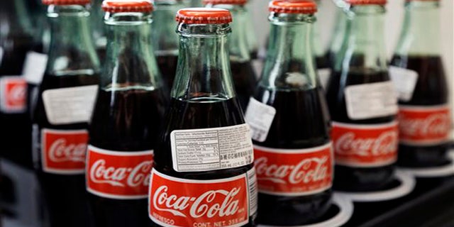 In this July 9, 2015 photo, bottles of Coca-Cola are on display at a Haverhill, Massachusetts.