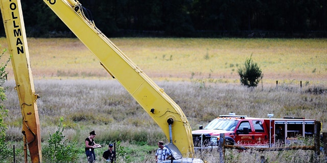 Sept. 23, 2013: Crews work to excavate a vehicle from an embankment near Beresford, S.D.
