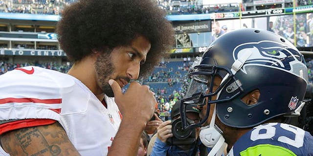San Francisco 49ers quarterback Colin Kaepernick, left, talks with Seattle Seahawks wide receiver Doug Baldwin, right, following an NFL football game, Sunday, Sept. 25, 2016, in Seattle. The Seahawks defeated the 49ers 37-18. (AP Photo/Ted S. Warren)