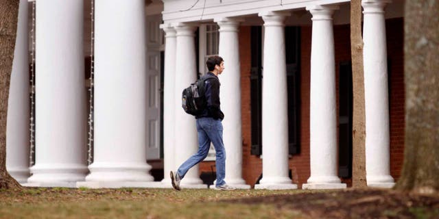 CHARLOTTESVILLE, VA - DECEMBER 6:  Garrett Durig, a fourth year student at the University of Virginia, walks across campus on December 6, 2014 in Charlottesville, Virginia. (Photo by Jay Paul/Getty Images)