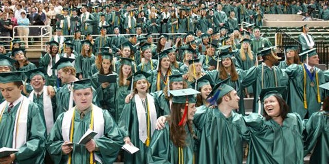 Michigan State University graduates as they sing their school's Alma Mater at the close of convocation ceremonies in East Lansing, Mich.