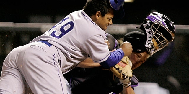 FILE 2006: Los Angeles Dodgers' Delwyn Young, left, is out at home plate as he collides with Colorado Rockies catcher JD Closser during the seventh inning of a baseball game in Denver.
