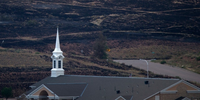 FILE: June 30, 2012. A church, which survived the Waldo Canyon Fire, is backdropped by a charred hillside in Colorado Springs, Colorado.