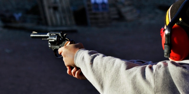Dec. 23, 2012: A man shoots a revolver, at Dragonman's firing range and gun dealer, outside Colorado Springs, Colo.