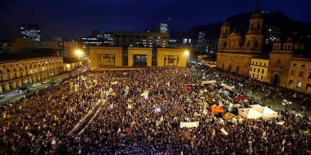 People gather at Bolívar square during a peace march in Bogotá, Colombia, Wednesday, Oct. 12, 2016.