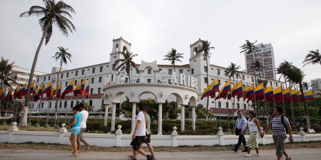 People walk past Hotel El Caribe in Cartagena, Colombia, Saturday April 14, 2012. The Secret Service sent home some of its agents for misconduct that occurred at the hotel before President Barack Obama's arrival on Friday for the Summit of the Americas. (AP Photo/Fernando Vergara)