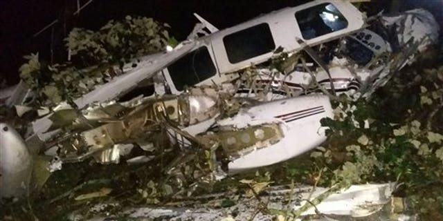 This photo released by the San Predro de los Milagros Fire Department shows the wreckage of a small plane assigned to the crew of a film starring Tom Cruise, that crashed, in a rural place of San Pedro de los Milagros, Colombia, Friday, Sept. 11, 2015. The country's civilian aviation authority said the twin-engine Aerostar crashed Friday after taking off from a small colonial town near Medellin, killing two people, including a Los Angeles-based film pilot, and seriously injuring a third. (San Pedro de los Milagros Fire Department via AP)